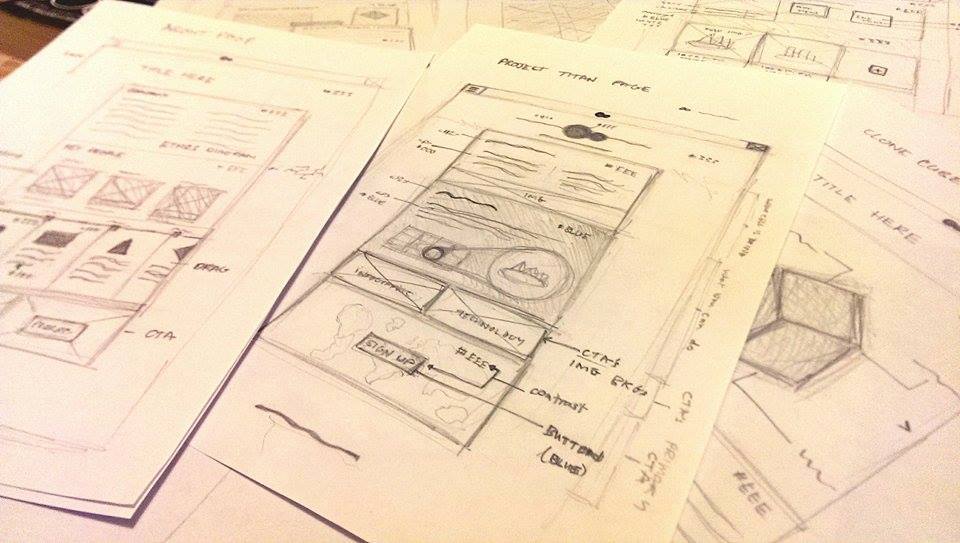 Various A4 sheets with hand-drawn wireframes of the user interfaces